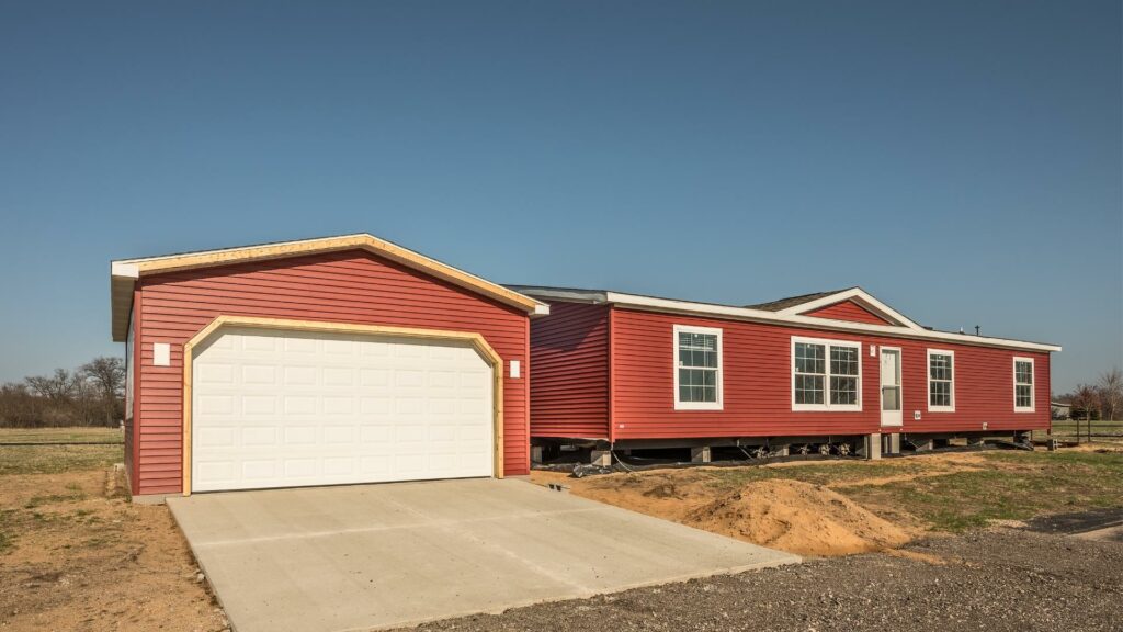 Newly installed manufactured home on grassy property.